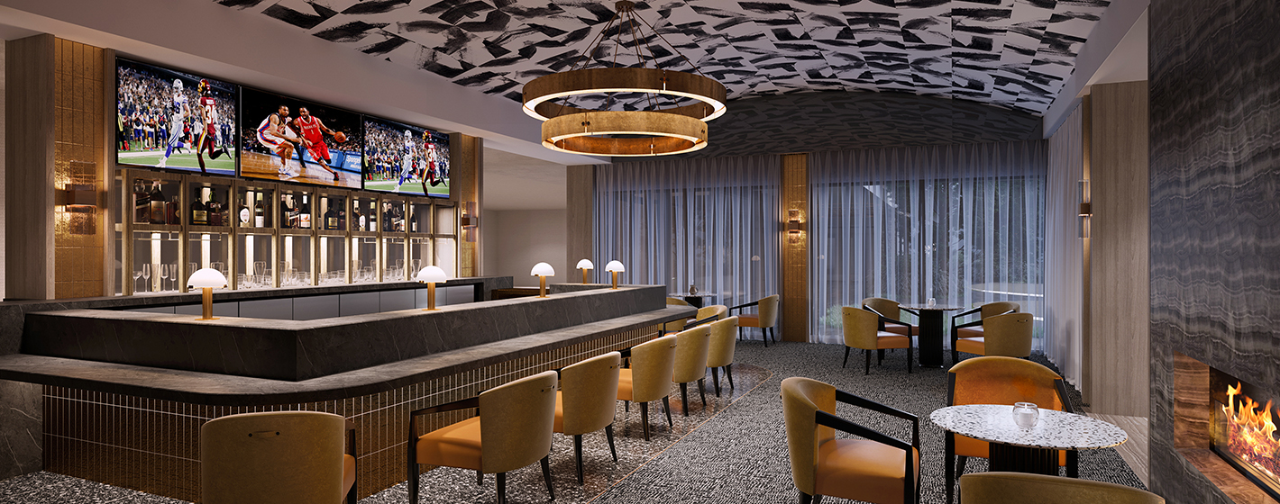 Stylish bar interior with a marble counter, plush seating, large TVs displaying sports, artistic ceiling design, soft lighting, and a cozy fireplace.